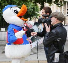 Photo : Interview d'un militant déguisé en canard à foie gras par deux journalistes